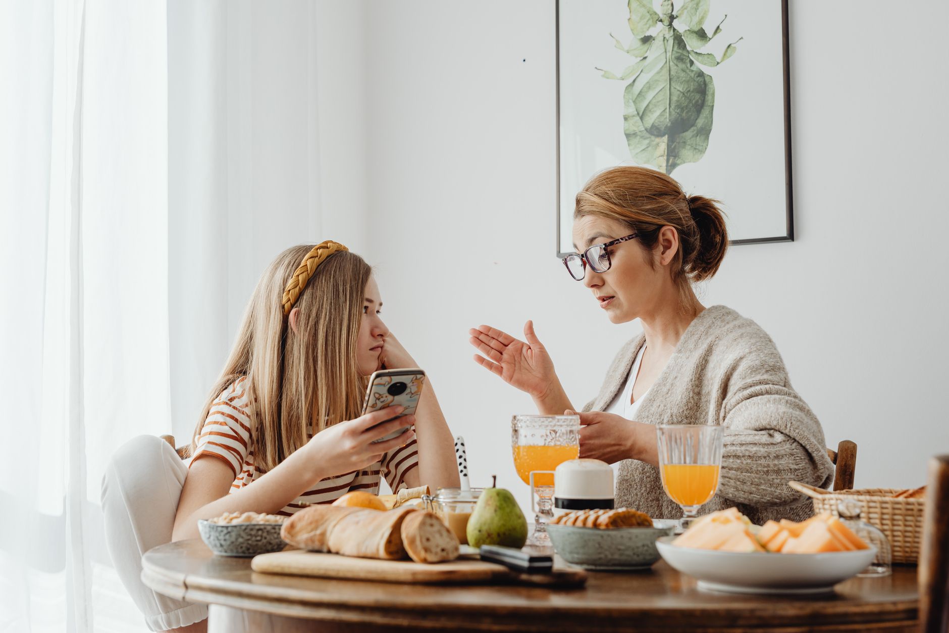 A parent and teenager talking together at home