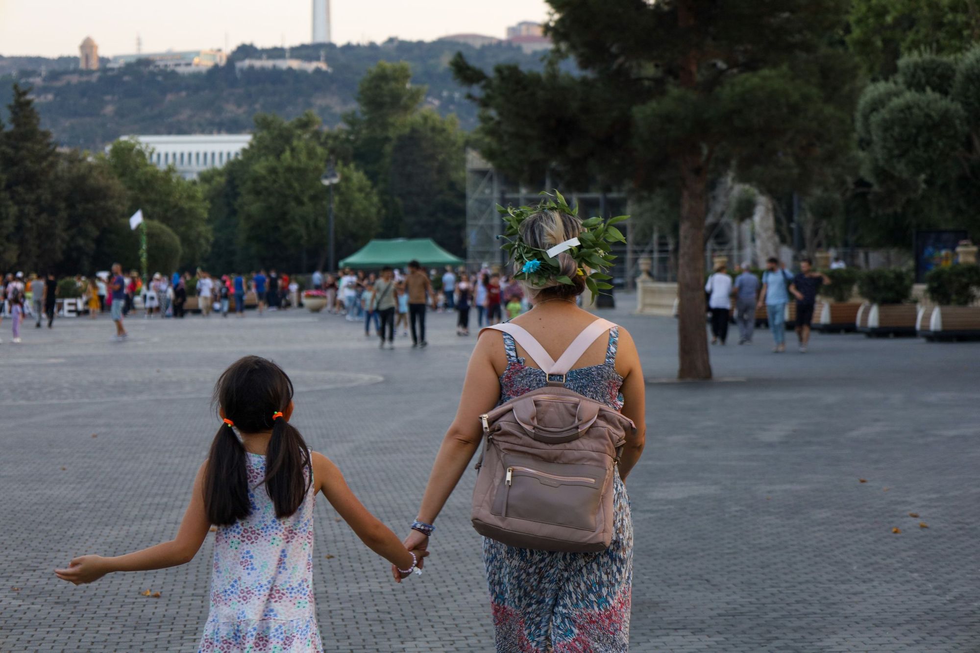 A parent and child walking hand in hand