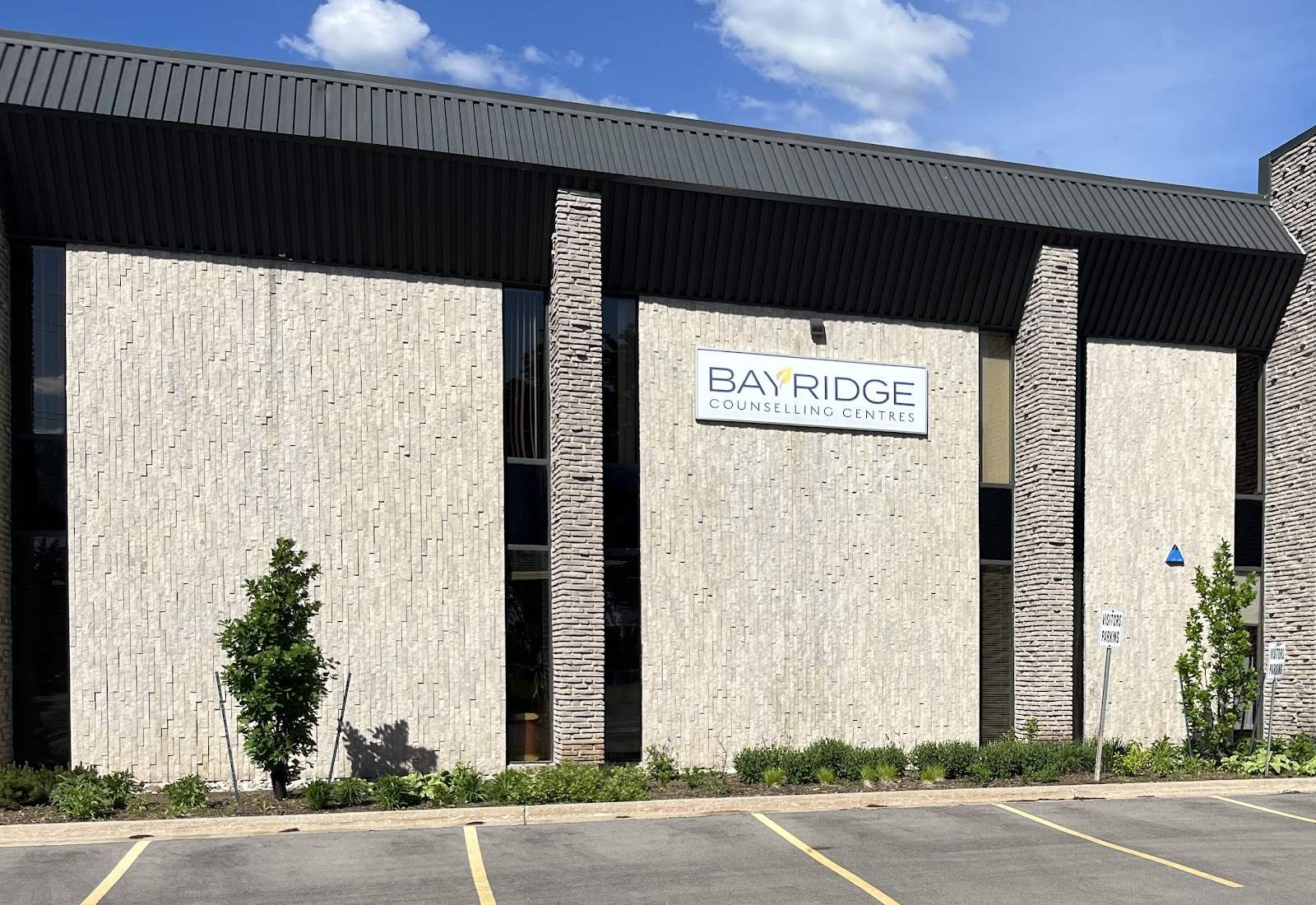 The Bayridge Counselling Centres sign on the front of the Burlington office building, with parking out front