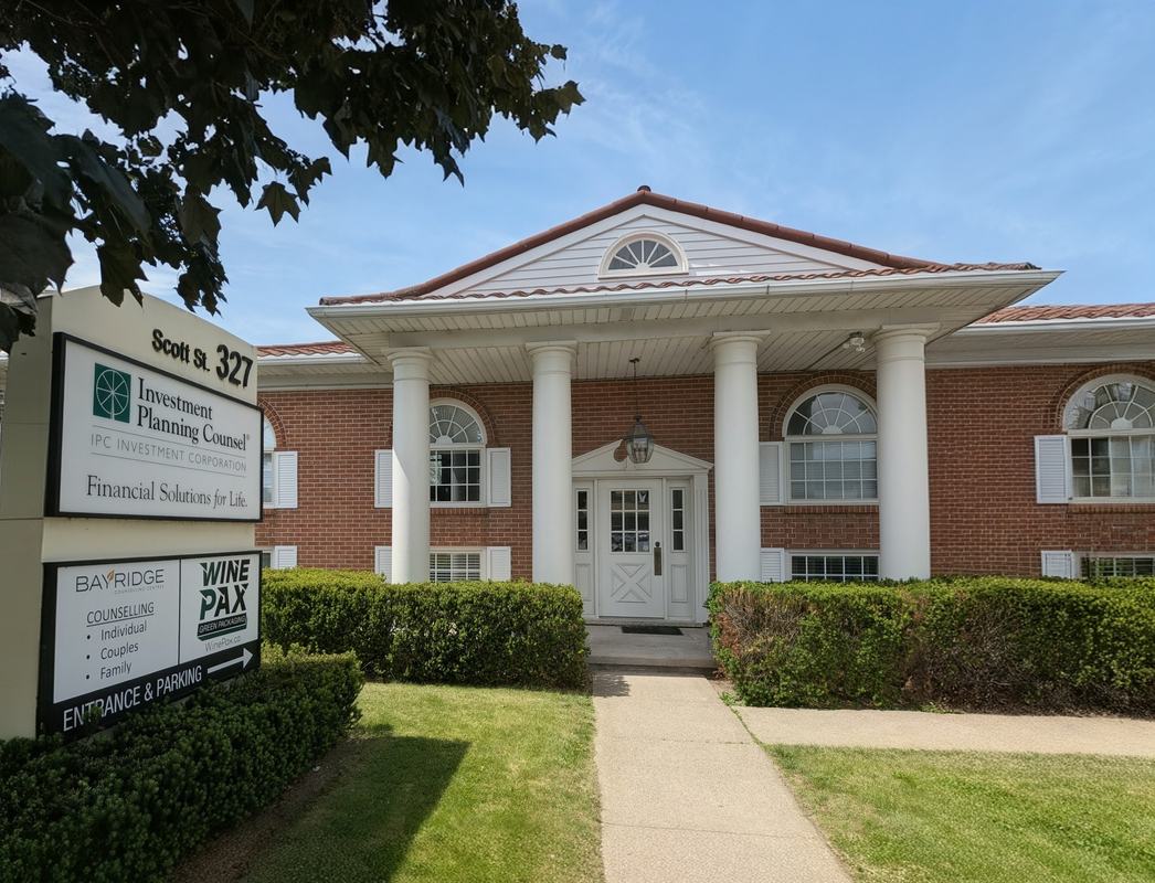 The pillared front of the St. Catharines office building, with its address sign out front