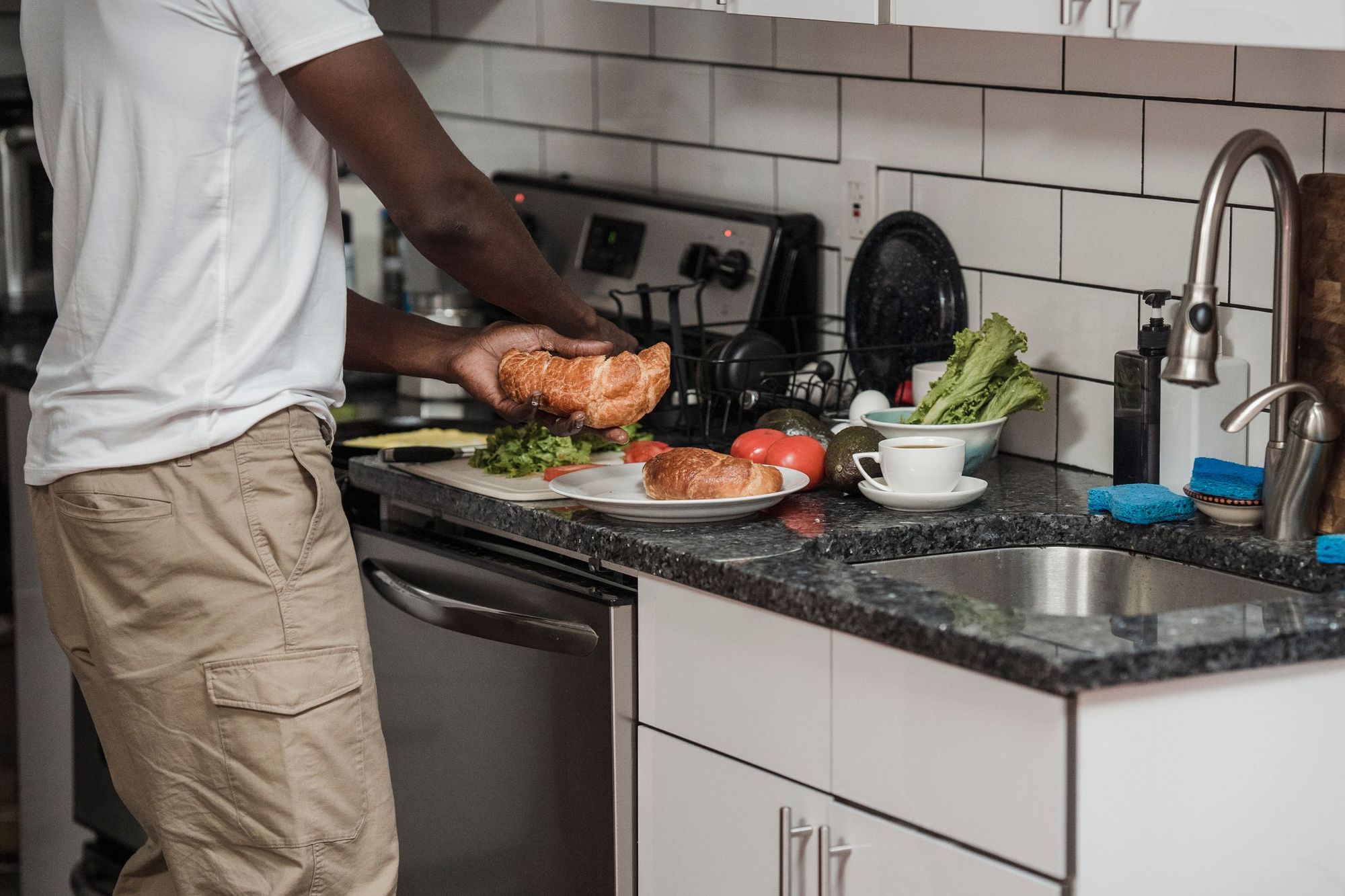 A man chopping vegetables in a bright kitchen