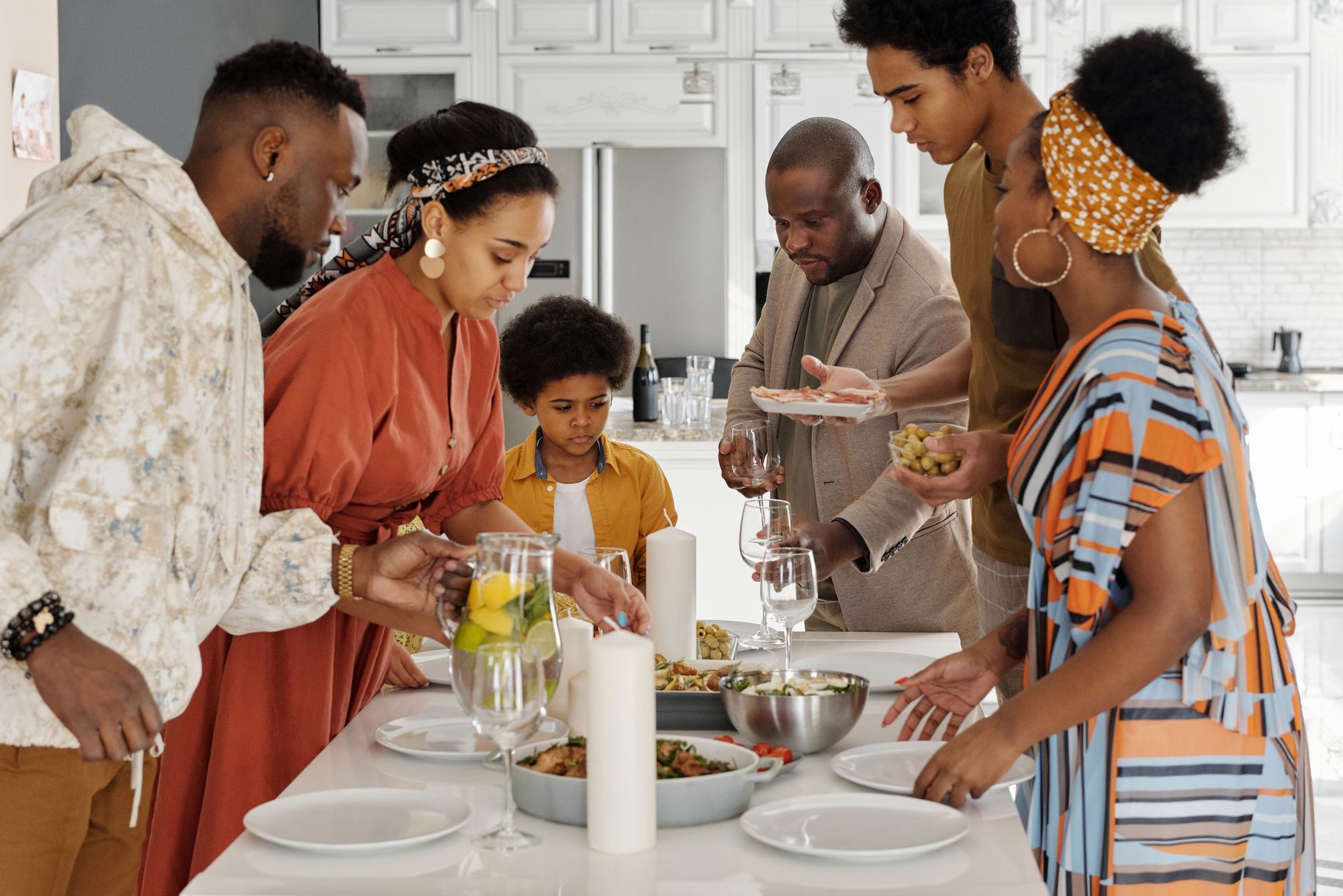 A family setting a dinner table together