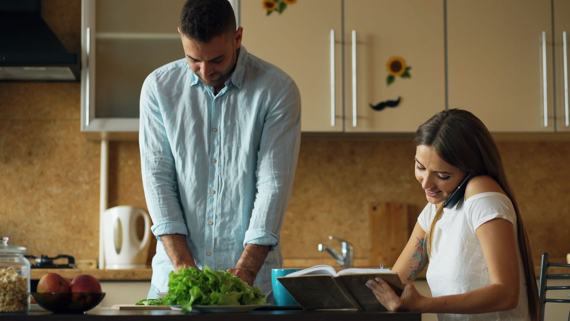 A couple cooking together in their kitchen