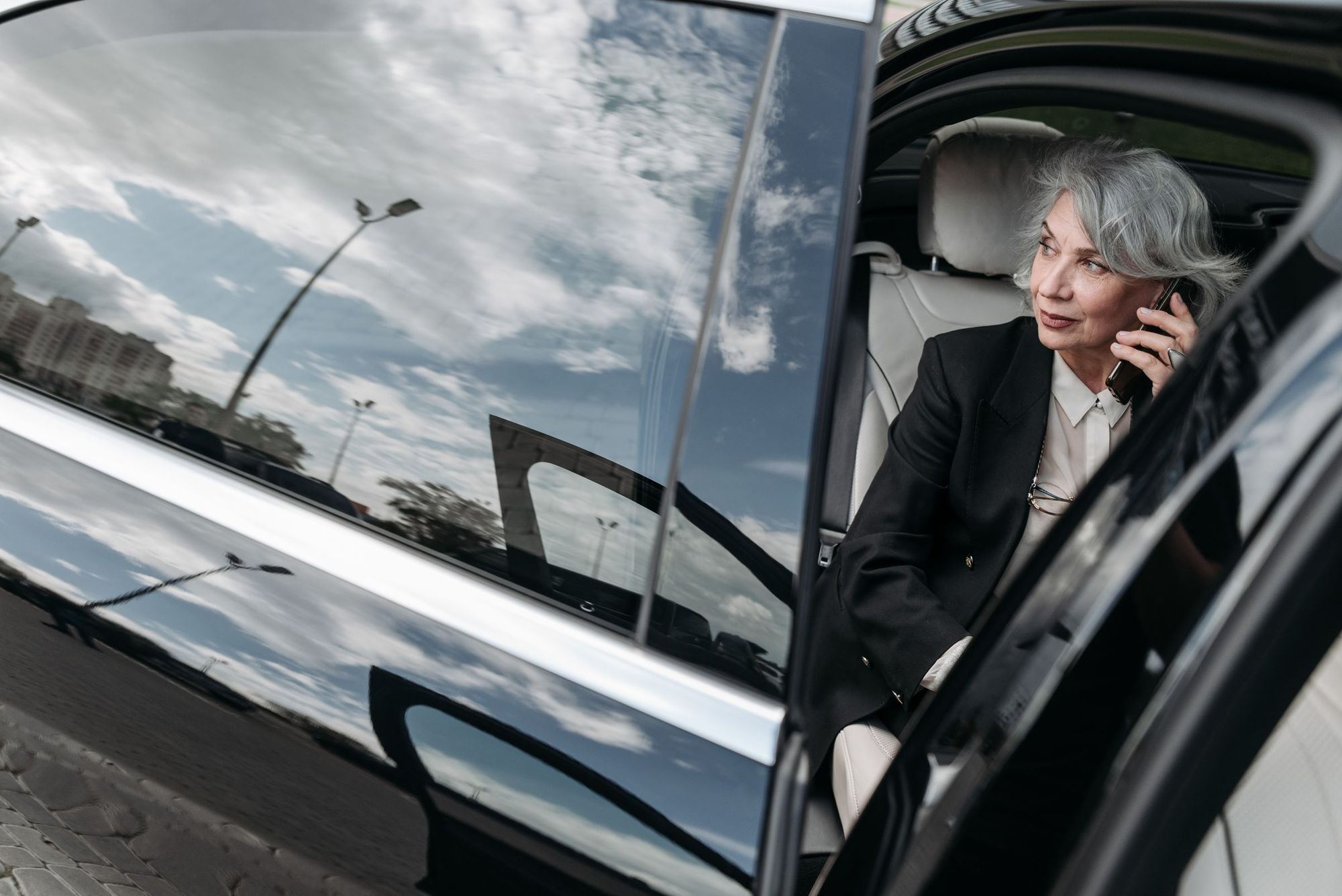 A woman on a phone call in her parked car