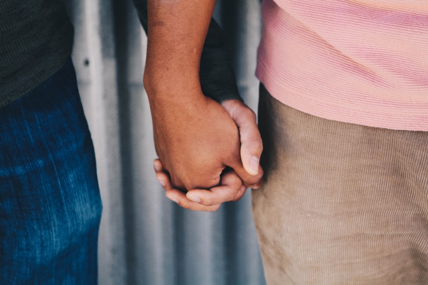 Two people holding hands